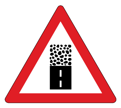 Tarred road becomes a gravel road ahead, with loose stones that can damage windscreens and paintwork